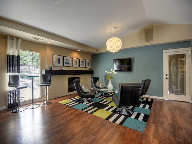 Office Interior with Glass Table, Black Sofa Chairs and Television
